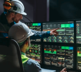 two guys reviewing activities at a system monitor